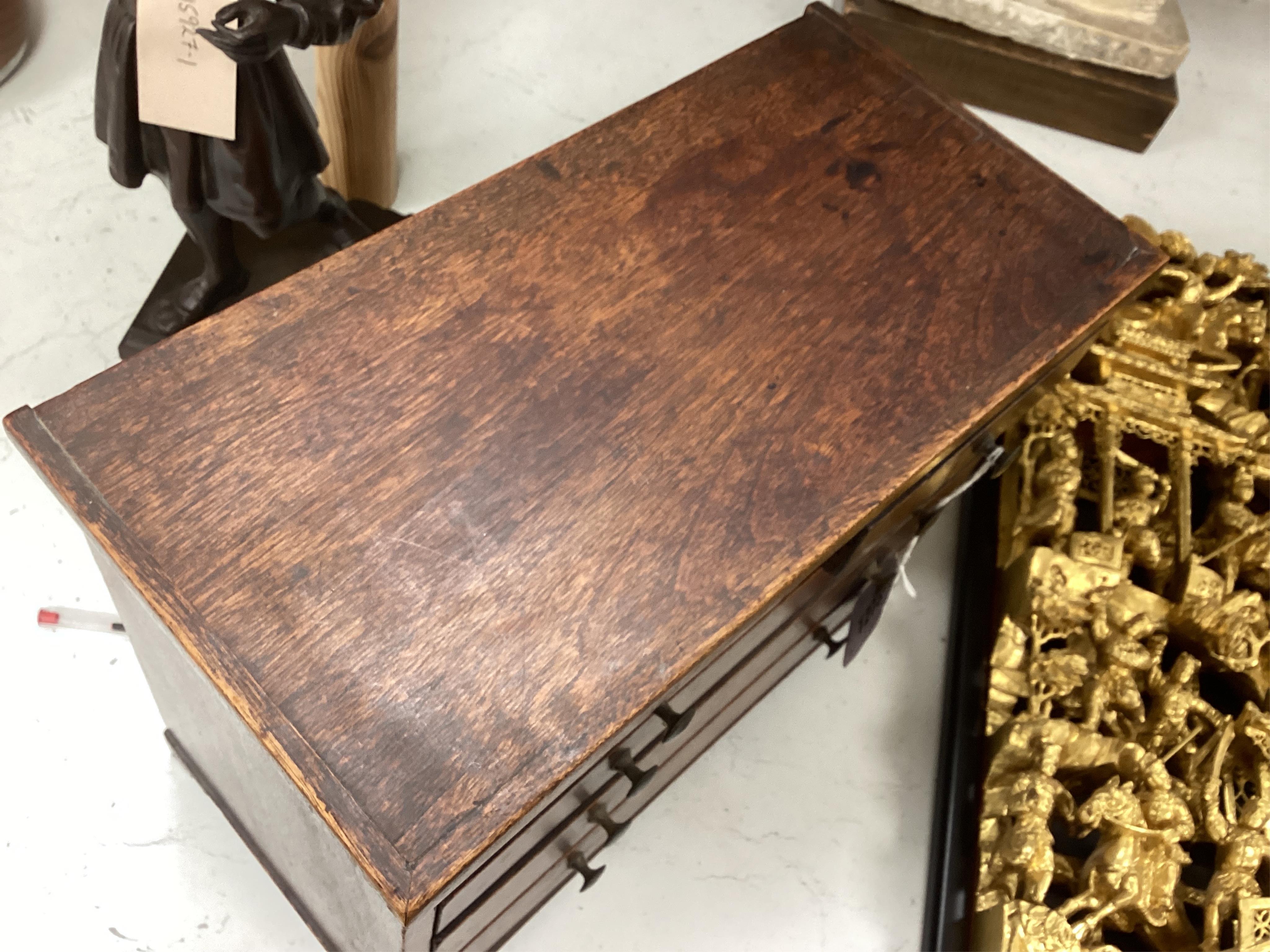 A miniature mahogany three long, two short, chest of drawers 32cms wide. Condition - good